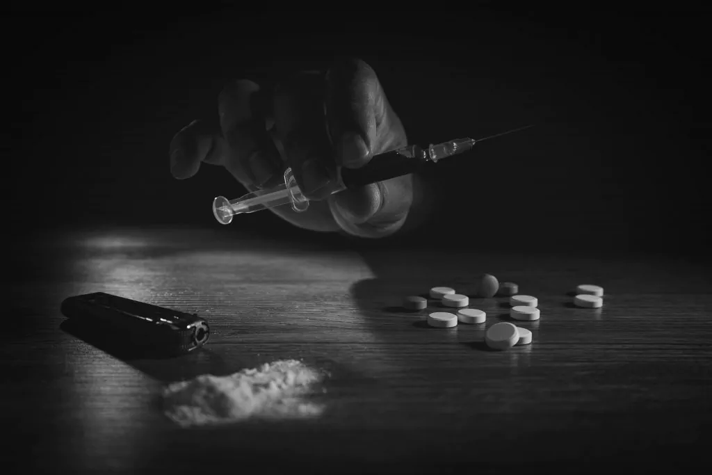 How to improve mental health 4. Say no to drugs (In picture: a hand holding syringe, some tablets on table and cocaine)