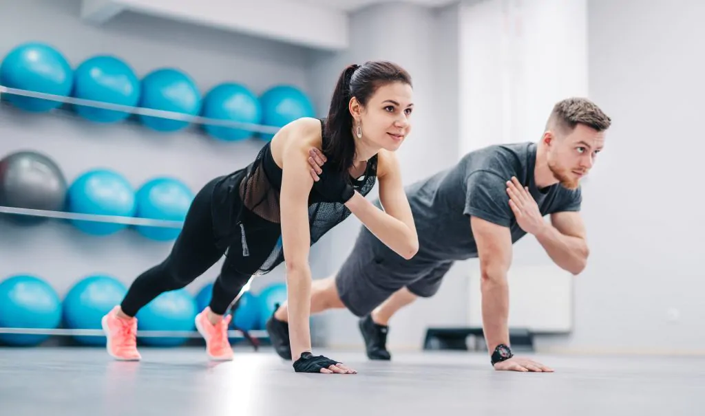 How to Improve mental health 1. Exercising (Two people doing pushups)